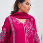Woman wearing a pink embroidered traditional outfit against a white background